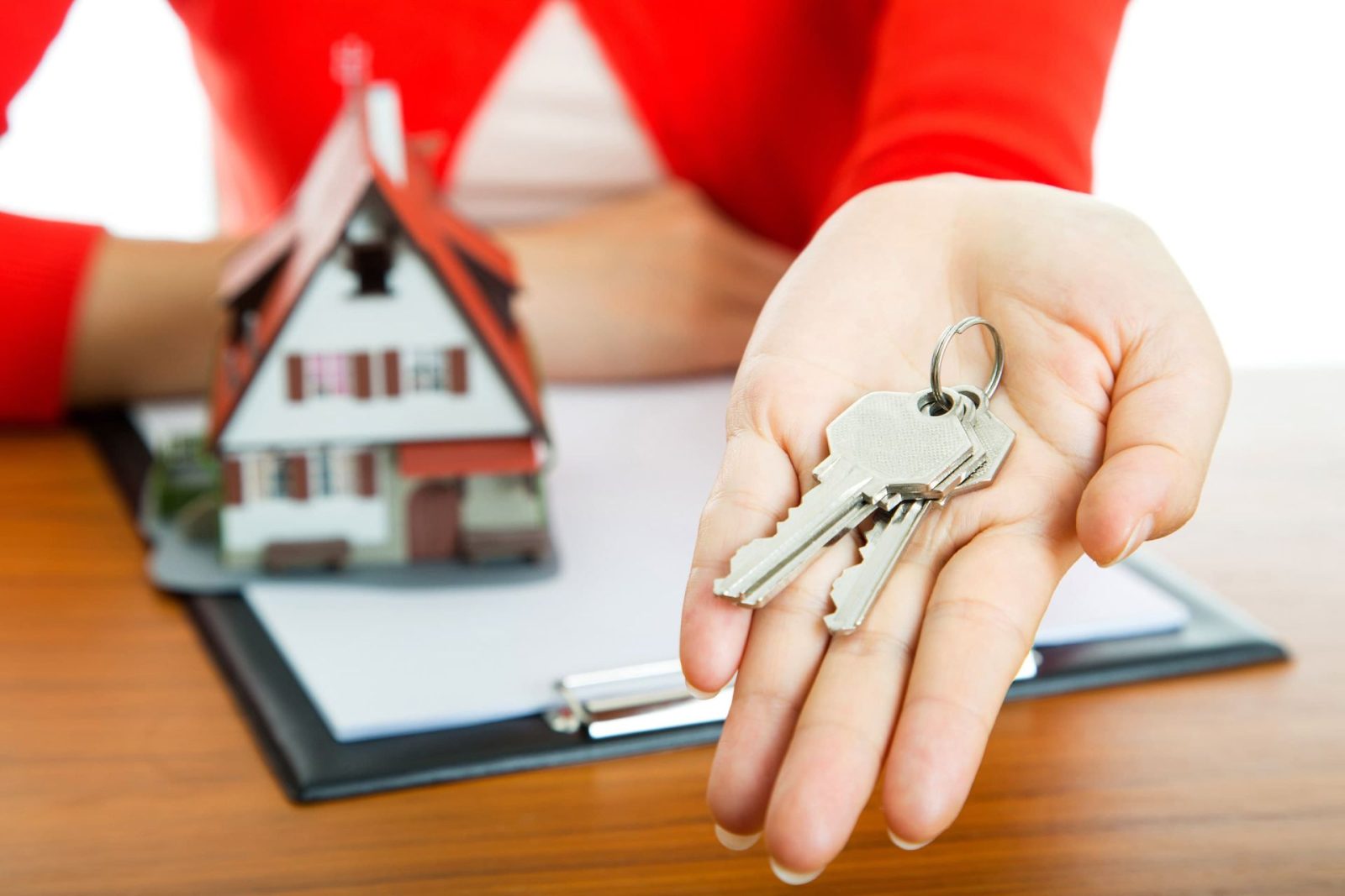 Mortgage broker holding a set of new house keys